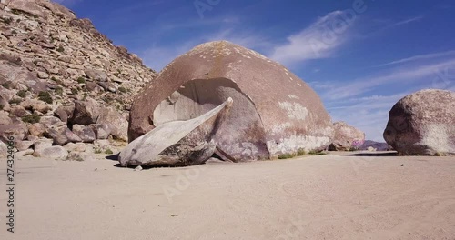 Largest Granite Boulder together cracked part  in Yucca Valley, California Desert aerial drone low angle parallax intro shot photo