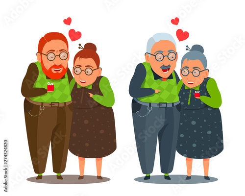Elderly man and woman hugging, standing together. Giving a gift. Couple in love. 