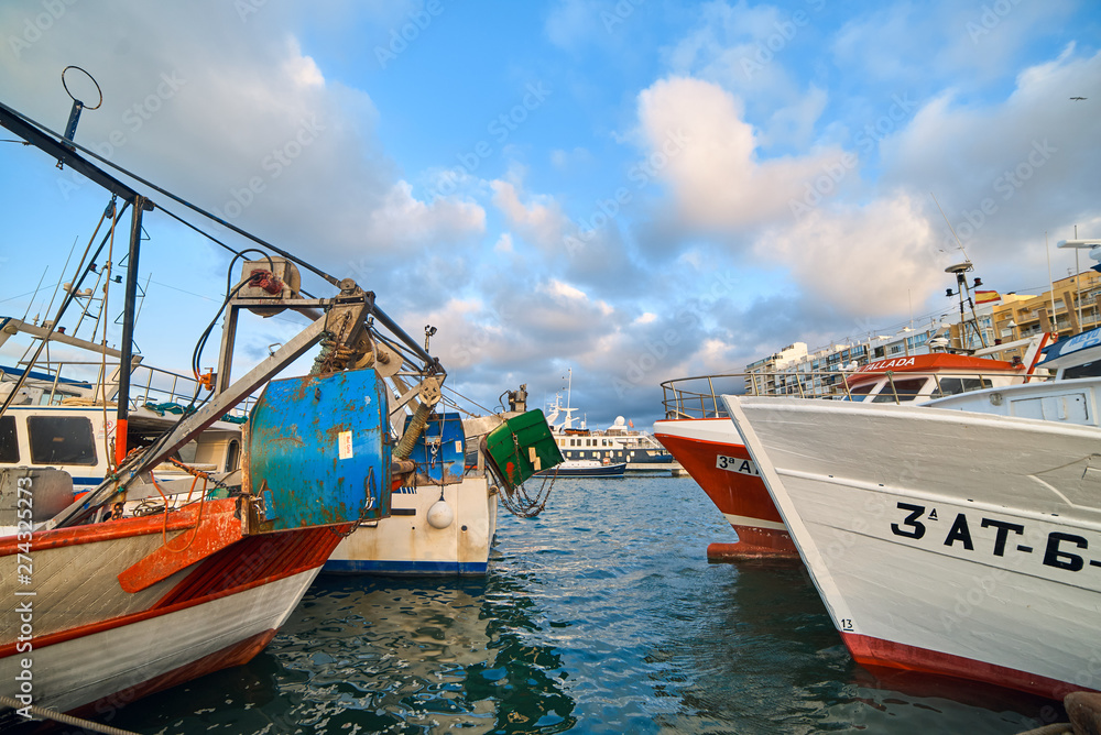 Obraz premium DENIA, SPAIN - JUNE 13, 2019: Fishing boat with ropes in the port of Denia town.