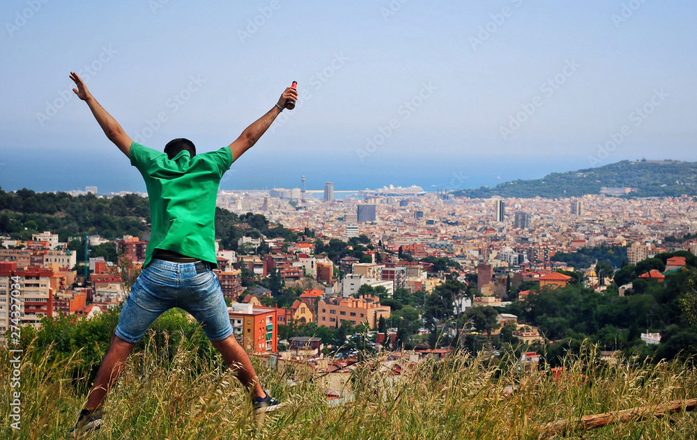 Fototapeta premium Man dressed in green jumping on the mountain.