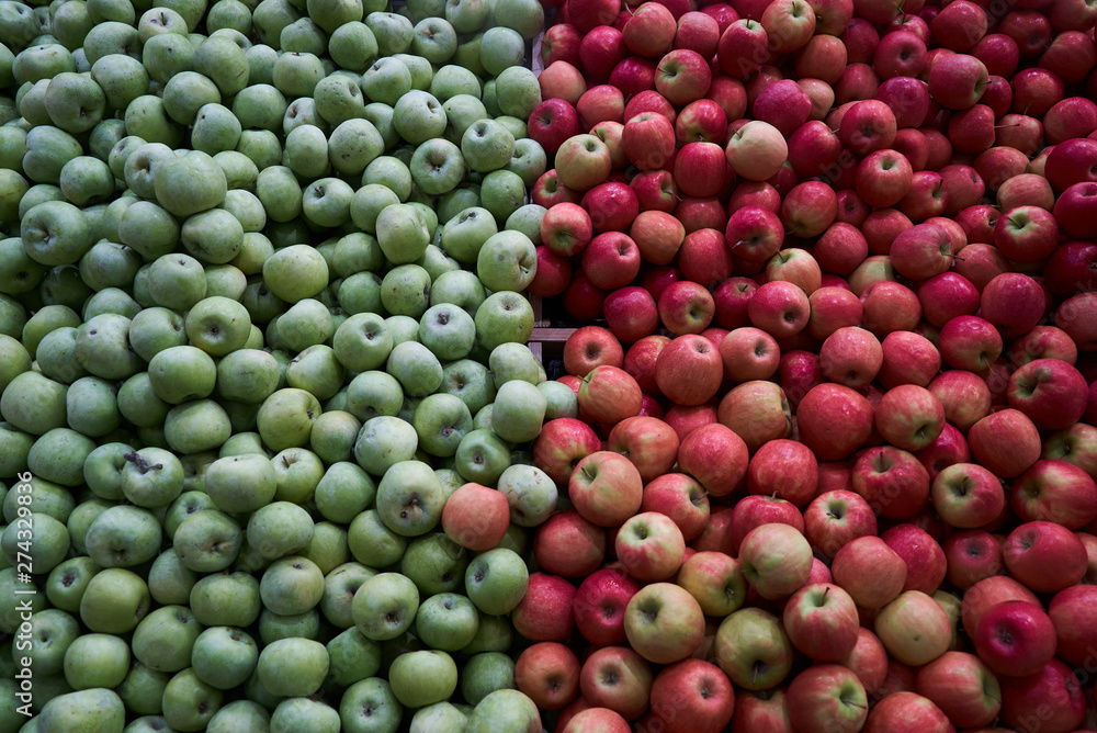 Green apples and red apples close-up. Fruit food background, close-up Green apples and red apples close-up. Fruit food background, close-up