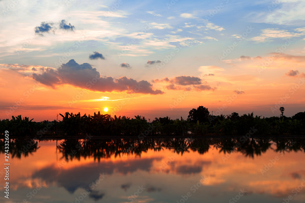A nature lake with beautiful sunset  reflection , ruction of sunset in lake 