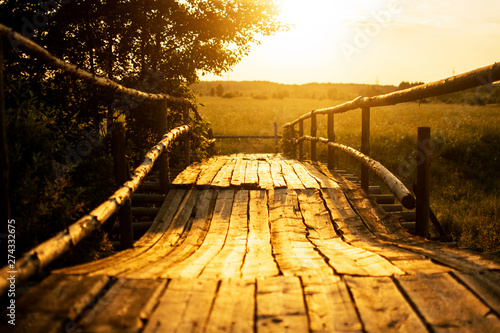 sunset over the old wooden bridge