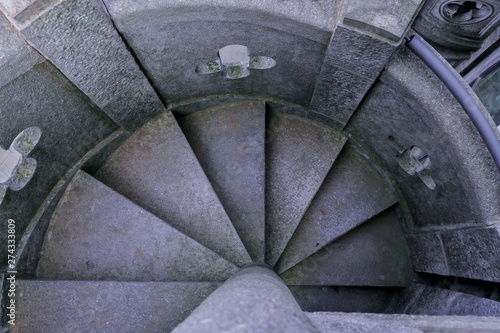 Ancient stone spiral-shaped stairs, edited photograph. 