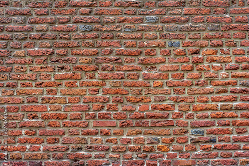 Real vintage Bumpy, rough and old brick texture with imperfect, dilapidate, impair , corroded and defective flemish brick bond pattern.