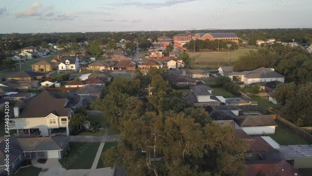 Cinematic Aerial of New Orleans Usa Suburbia With Residental Houses and Soccer Field Under Evening Spring Sun Cinematic Aerial of New Orleans Usa Suburbia With Residental Houses and Soccer Field Under Evening Spring Sun