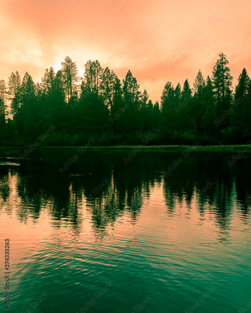 Reflection of the Willamette River near Bend, Oregon during sunset Reflection of the Willamette River near Bend, Oregon during sunset
