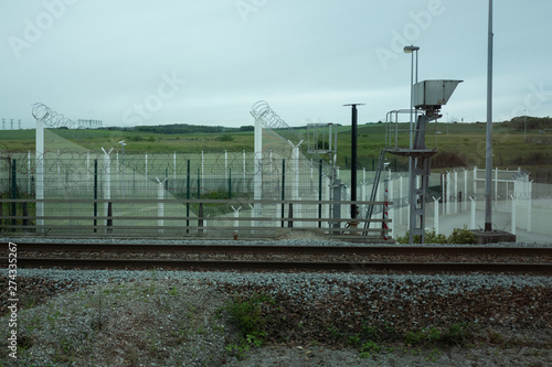 Security fencing at entrance to cross channel tunnel preventing illegal immigration
