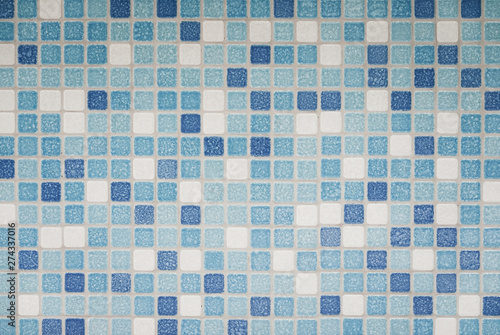 Background and texture of Mosaic tiles in blue, azure and white on decorative wall .