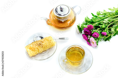 Greek sweet "Diples" and a cup of tea on a white background