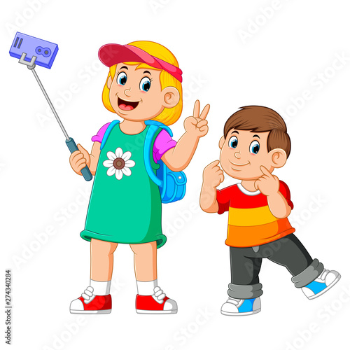 the children are posing and taking a selfie together