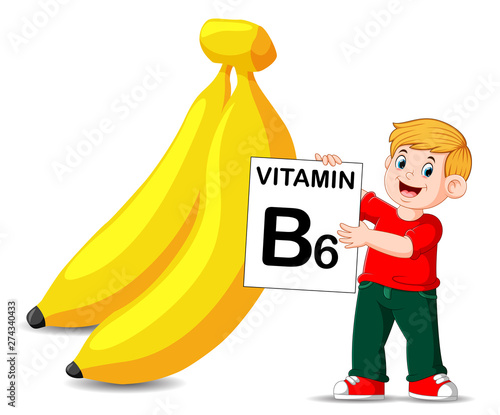 the boy beside the banana is holding the vitamin B6 board