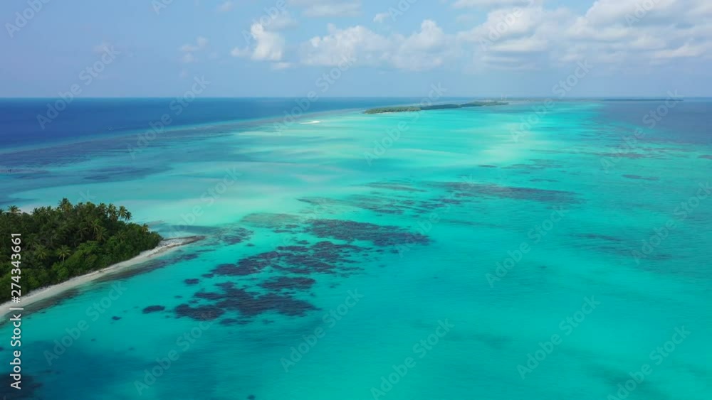 astonishing aerial drone shot of grand Anse beach on La Digue island, surrounded by crystal clear water with corals, Seychelles.Victoria astonishing aerial drone shot of grand Anse beach on La Digue island, surrounded by crystal clear water with corals, Seychelles.Victoria