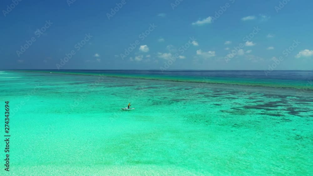 fisherman in long tail boat in the crystal clear endless sea, Baa Atoll, Maldives fisherman in long tail boat in the crystal clear endless sea, Baa Atoll, Maldives