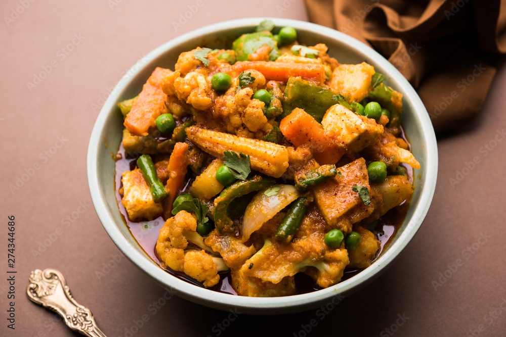 Mix vegetable curry - Indian main course recipe contains Carrots, cauliflower, green peas and beans, baby corn, capsicum and paneer/cottage cheese with traditional masala and curry, selective focus Mix vegetable curry - Indian main course recipe contains Carrots, cauliflower, green peas and beans, baby corn, capsicum and paneer/cottage cheese with traditional masala and curry, selective focus