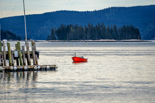 Obraz na plátne A Single Rowboat Tenders Small Boas Moored Off a Dock in Maine