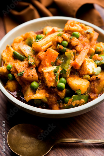 Mix vegetable curry - Indian main course recipe contains Carrots, cauliflower, green peas and beans, baby corn, capsicum and paneer/cottage cheese with traditional masala and curry, selective focus