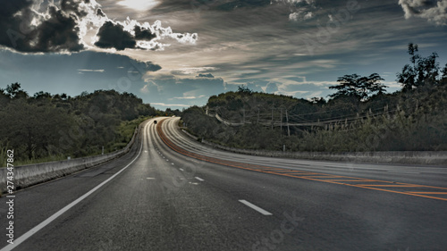 Mountain roads and green trees blur.