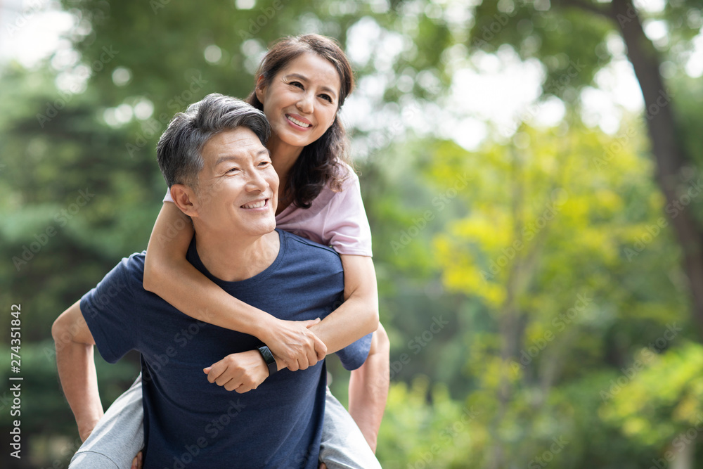 Happy mature couple relaxing in park Happy mature couple relaxing in park