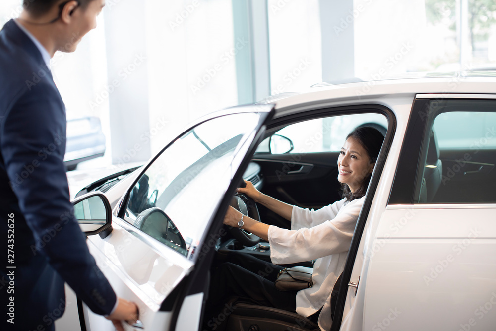 Happy mature woman taking a test drive Happy mature woman taking a test drive