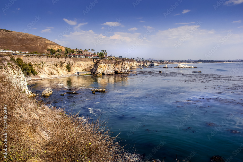 Coastal cliffs overlooking a glistening blue sea