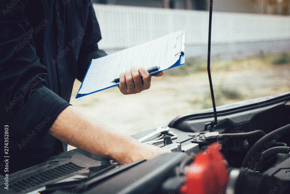 Car mechanic repairing vehicle engine working job. Car mechanic repairing vehicle engine working job.