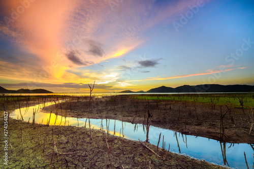 Wallpaper Mural crack run dry arid of the water in lake at summer dry season of tropical area, sunset scenery at the low water of the lake side Torontodigital.ca