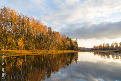 autumn landscape with lake and blue sky © Alexey Kartsev