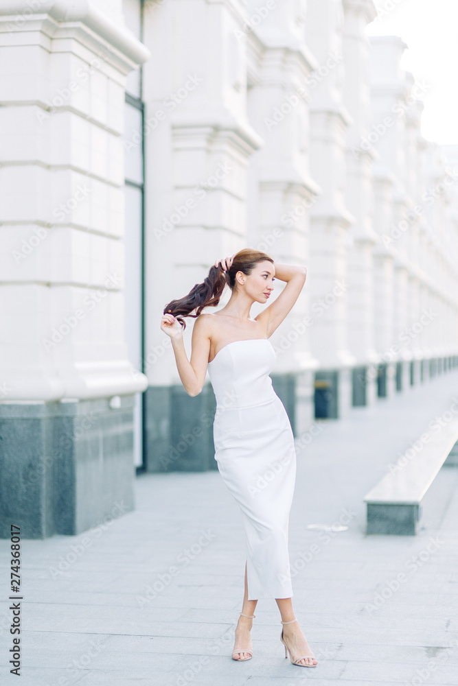 Summer look and white dress. Portraits of an elegant girl with luxury apartments. Summer look and white dress. Portraits of an elegant girl with luxury apartments.