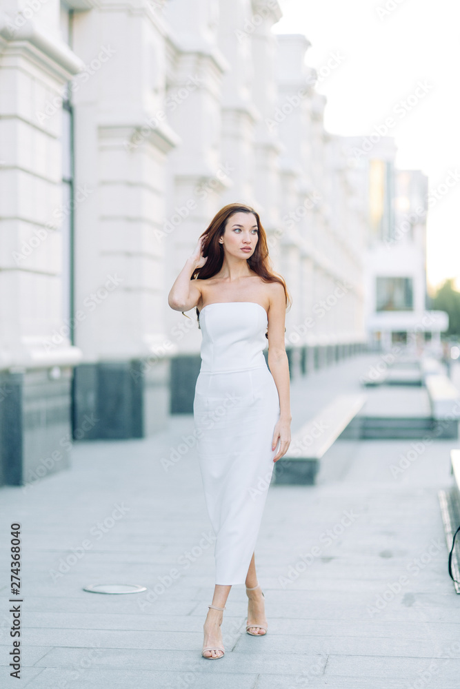  Summer look and white dress. Portraits of an elegant girl with luxury apartments.