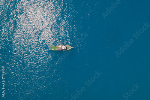 Fototapeta Naklejka Na Ścianę i Meble -  Aerial View Of Boat In Deep Blue Sea Water, Gelendzhik, Russia