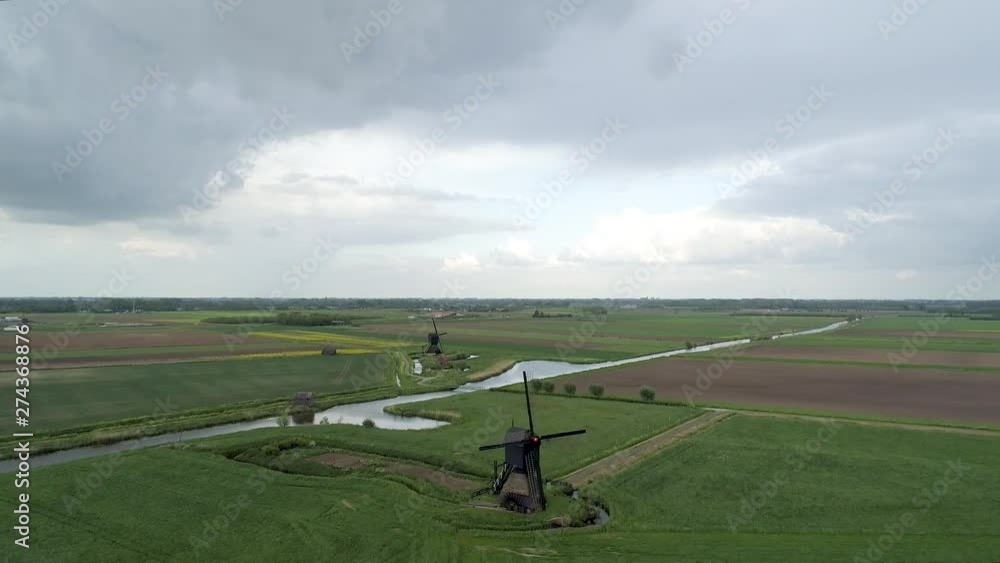 AERIAL pull back shot revealing old Dutch windmills. AERIAL pull back shot revealing old Dutch windmills.