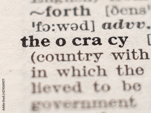 Dictionary definition of word theocracy, selective focus.