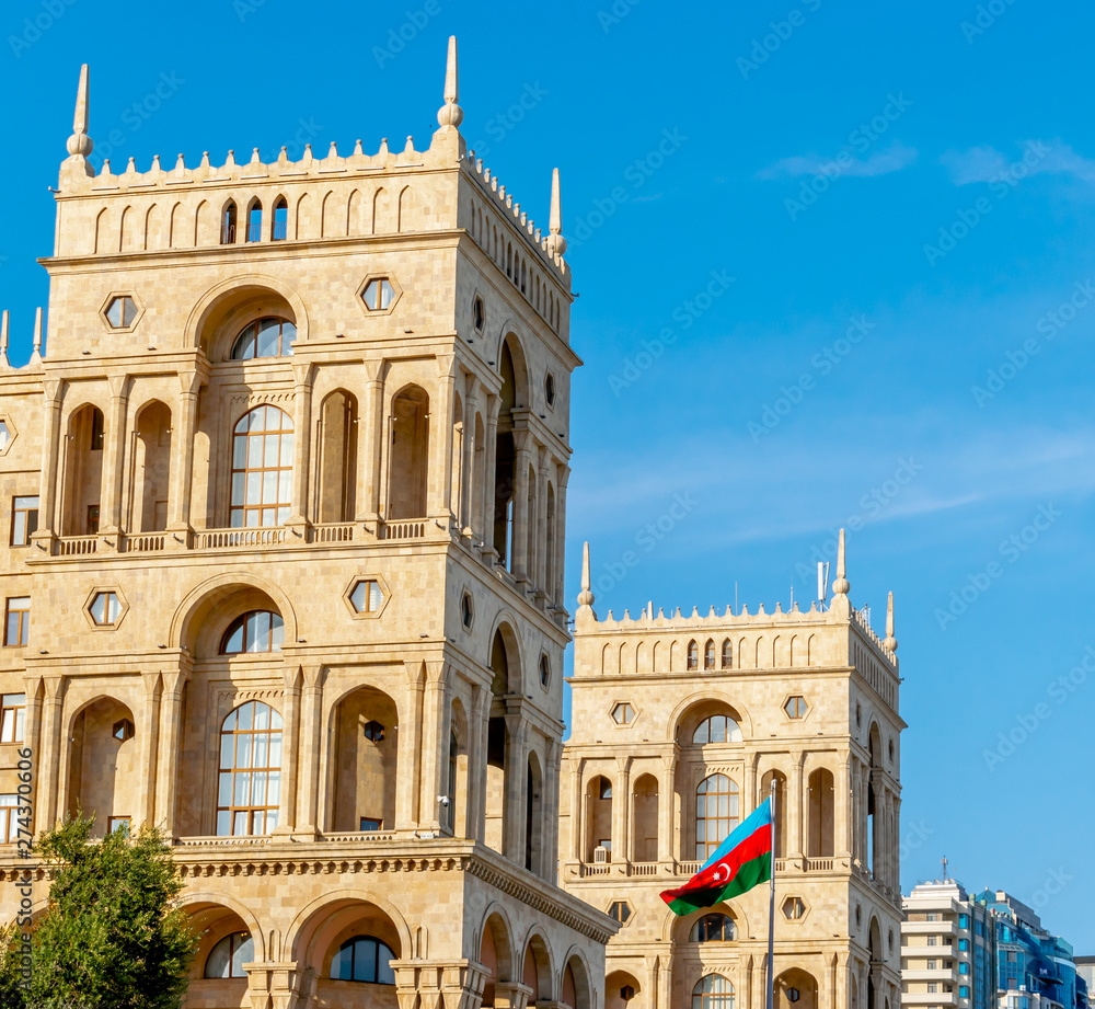 Baku, Azerbaijan - May 22, 2019: Government`s House on Freedom square and Flag of Azerbaijan