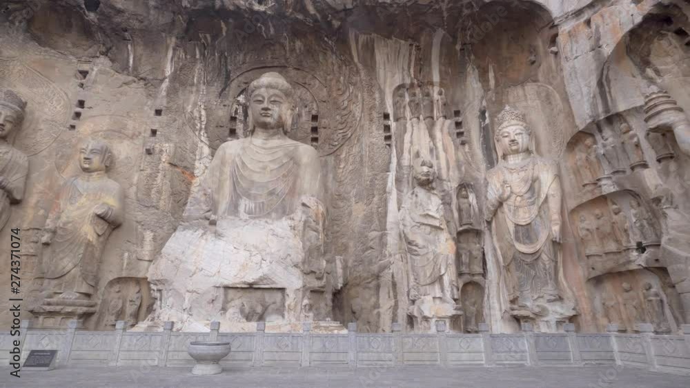 Panorama of the giant buddhist sculptures in the main Longmen Grotto (Fengxian Cave). Chinese Buddhist and finest art Longmen Caves, Luoyang, Henan province, China Panorama of the giant buddhist sculptures in the main Longmen Grotto (Fengxian Cave). Chinese Buddhist and finest art Longmen Caves, Luoyang, Henan province, China