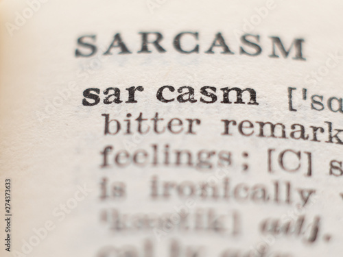 Dictionary definition of word sarcasm, selective focus. photo