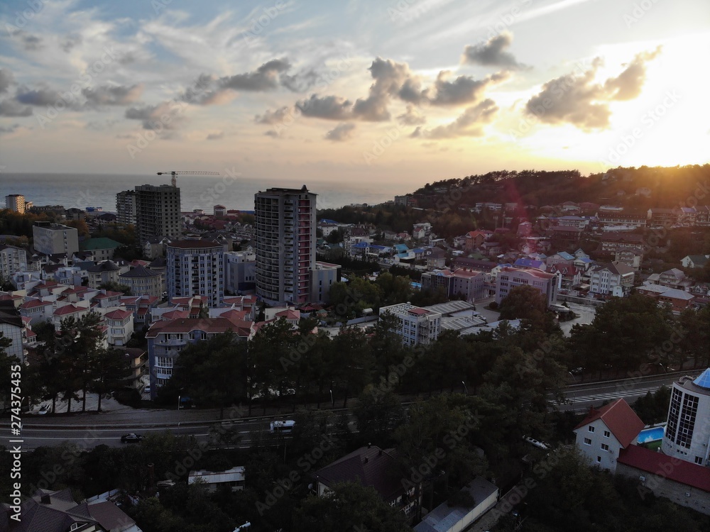 Fototapeta premium View from the camera drone at sunset in the resort town,mountains,clouds