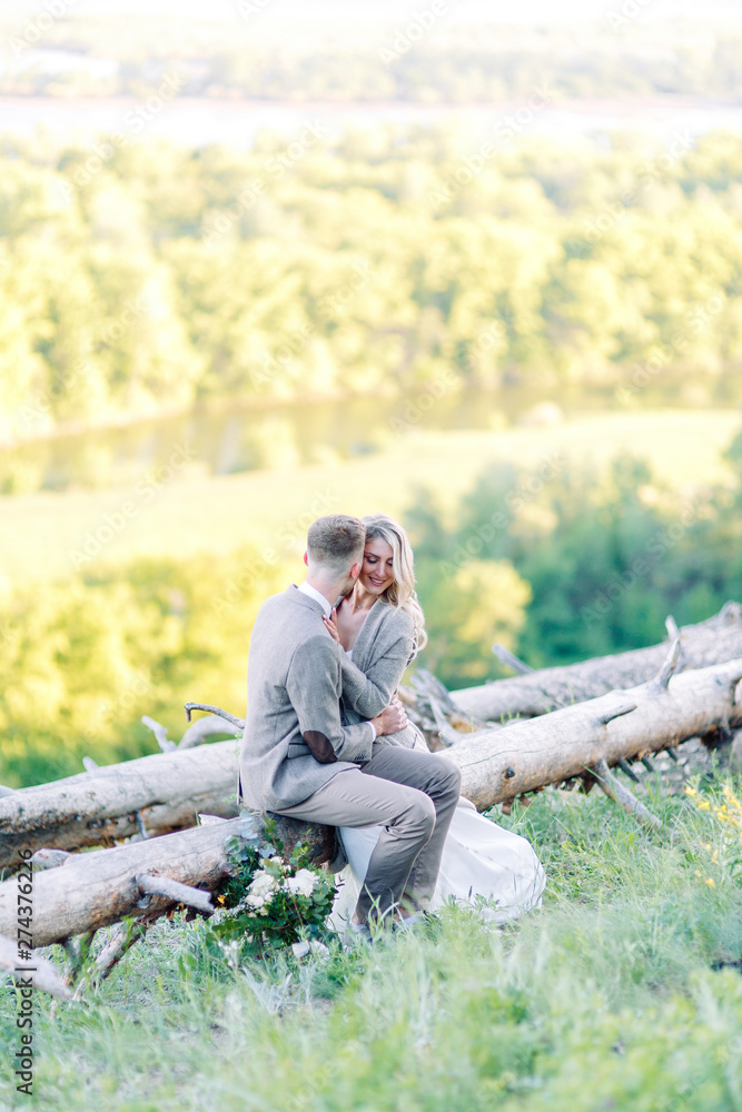 Fototapeta premium Beautiful love story in the woods. Wedding couple photo shoot in nature.