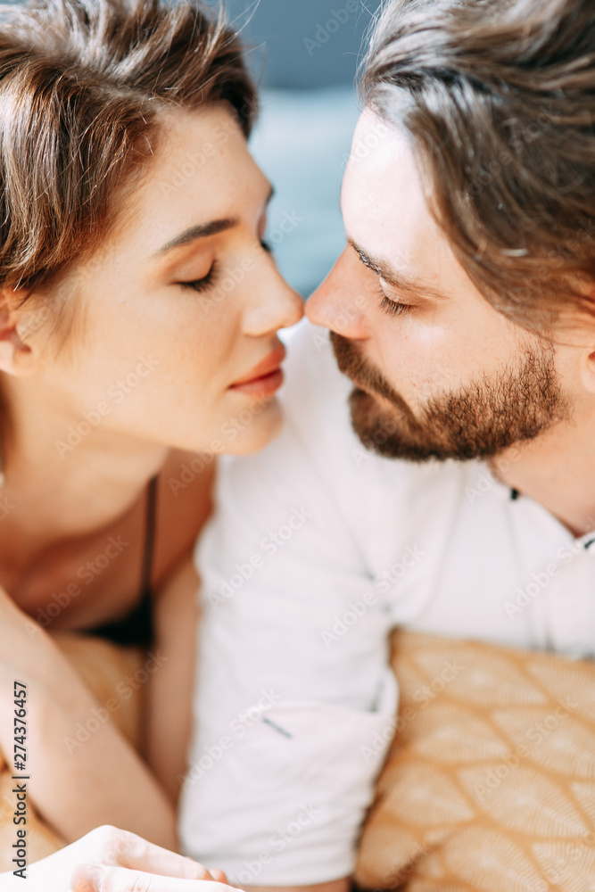 sensual photo shoot on the bed. Stylish young couple in the interior Studio. sensual photo shoot on the bed. Stylish young couple in the interior Studio.