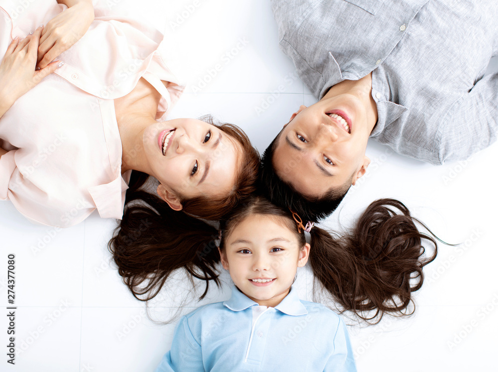 Top view of Happy asian Family lying on the floor