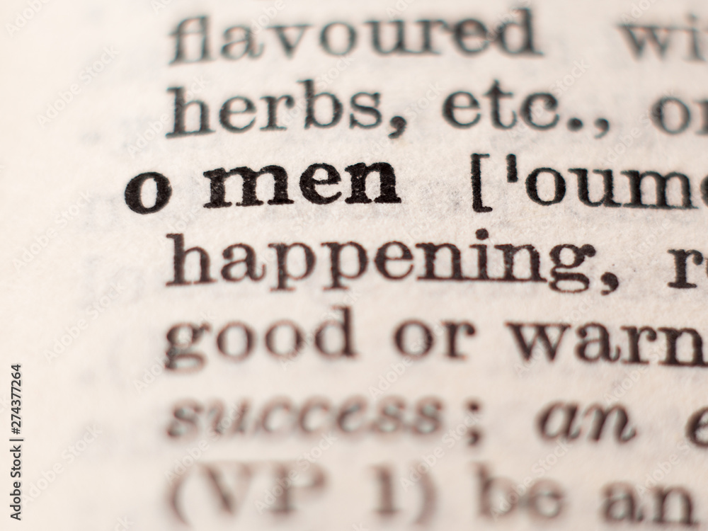 Dictionary definition of word omen, selective focus. Dictionary definition of word omen, selective focus.