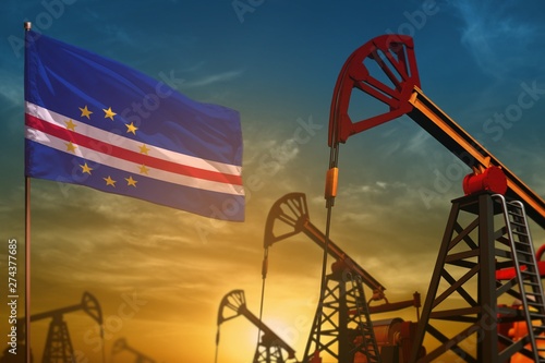 Cabo Verde oil industry concept. Industrial illustration - Cabo Verde flag and oil wells against the blue and yellow sunset sky background - 3D illustration © Dancing Man