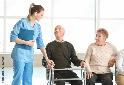Young caregiver with group ...