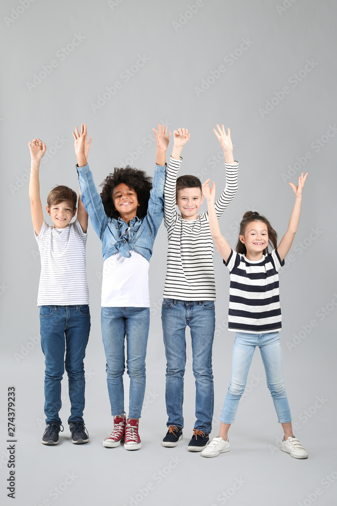 Obraz premium Happy children in jeans on grey background