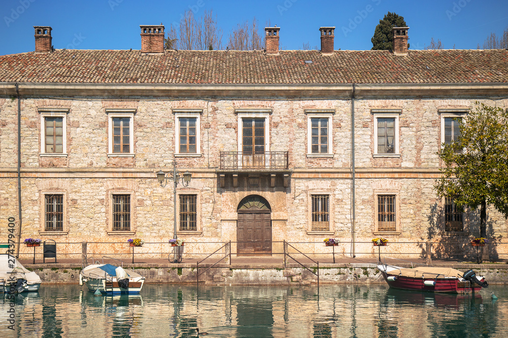 old northen italian building exterior. Ancient barracks, the place is Peschiera del Garda in Veneto region near Verona