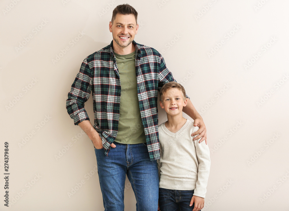 Happy man with little adopted boy on white background Happy man with little adopted boy on white background