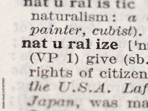 Dictionary definition of word naturalize, selective focus.