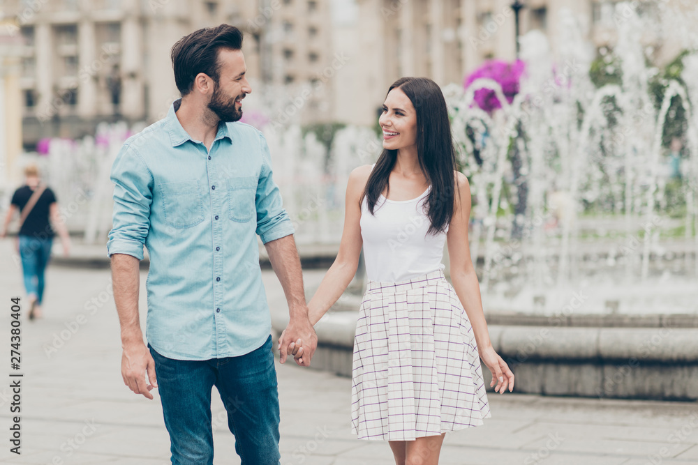 Portrait of excited millennial people person youth bearded fun funny cute charming lovely promenade town outside fountain dress skirt denim jeans shirt blue