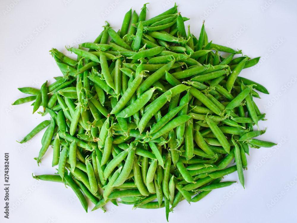 Green peas in bills on a white background. Vegetarian. Proper nutrition. Green peas in bills on a white background. Vegetarian. Proper nutrition.