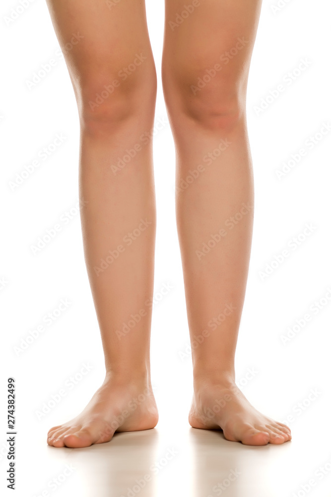 Front view of female barefoot legs on white background Front view of female barefoot legs on white background